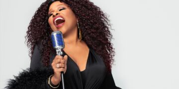A photo of singer Chaka Khan singing into a microphone