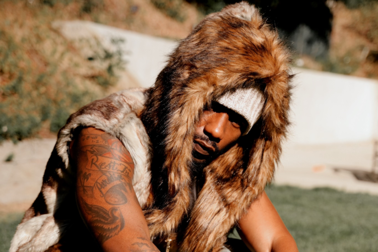 R&B singer Phabo pictured outside wearing a fur coat