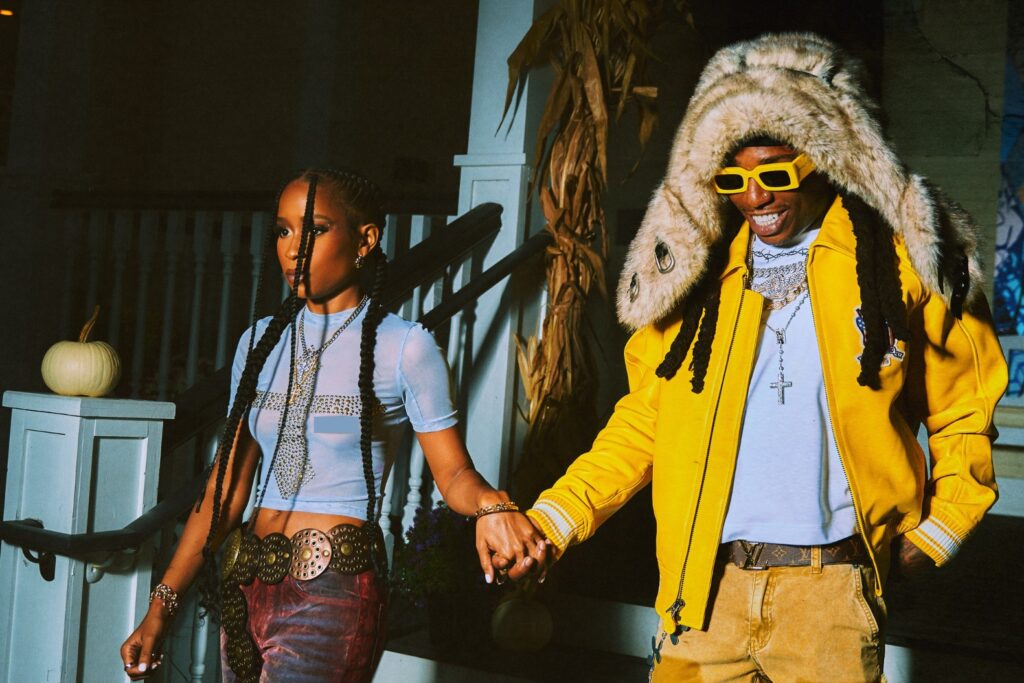 A photo of DeJ Loaf and Jacquees holding hands