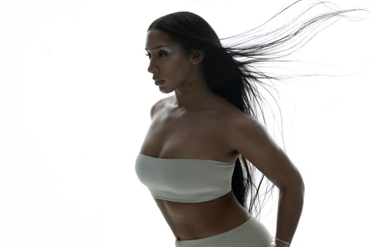 A photo of singer Naomi Sharon against a white backdrop.