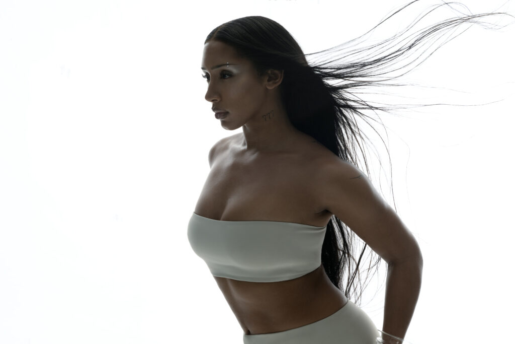 A picture of the singer Naomi Sharon against a white background.