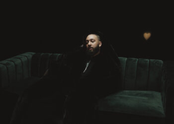 Isaiah Falls sitting on a green couch