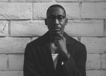 A black and white photo of singer Raphael Saadiq